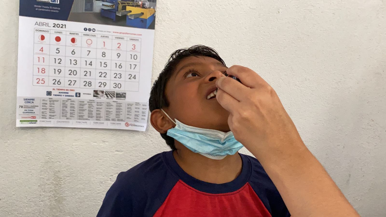 Kids receiving worm medicine at Nueva Vida church in the city